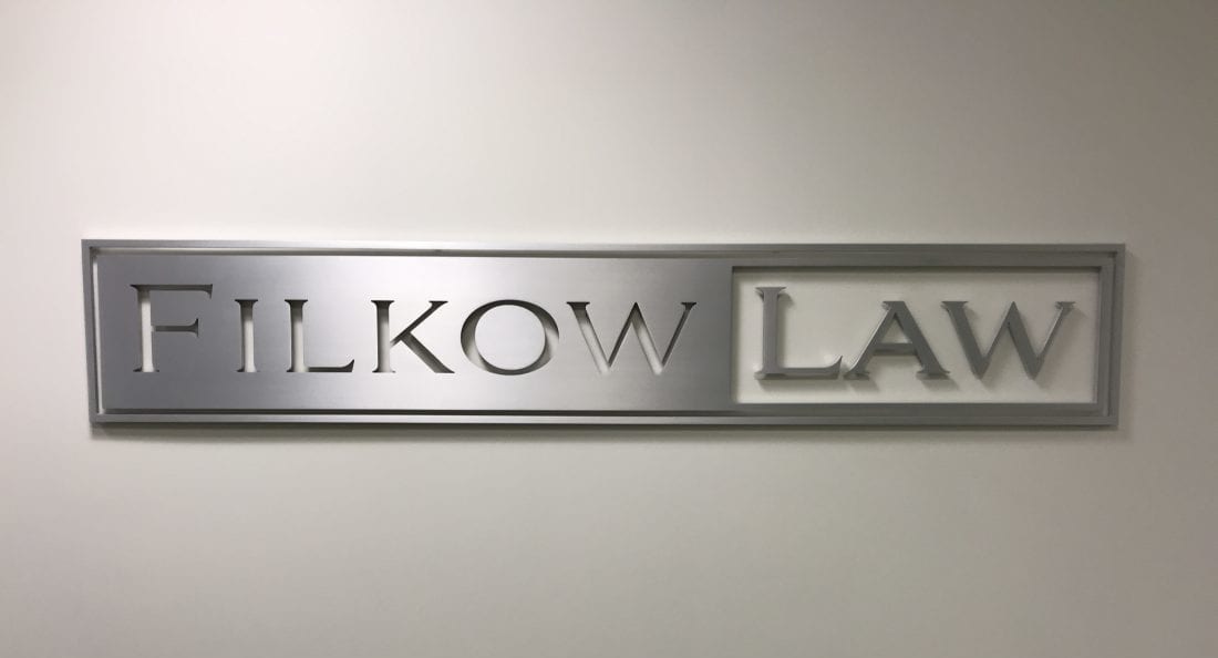filkow law sign hung on wall in office