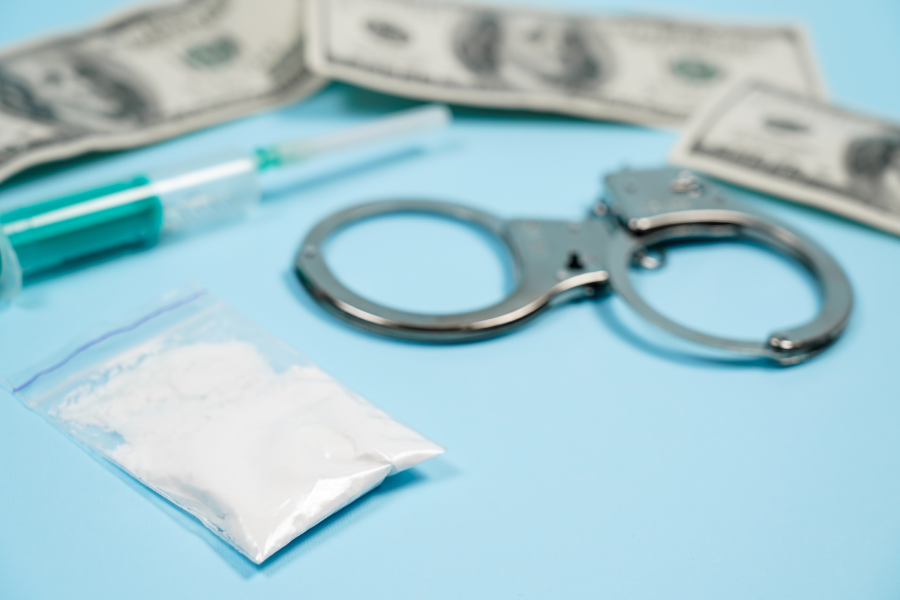 police evidence, money and drugs on table top