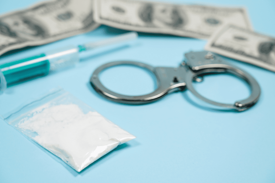 police evidence, money and drugs on table top