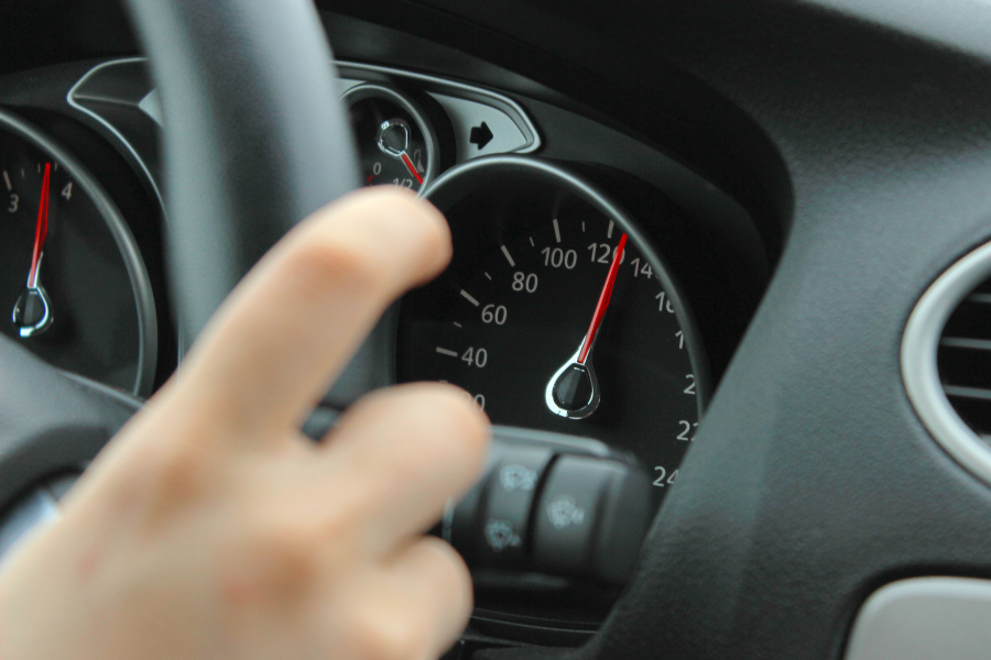 car speedometer shows car is speeding