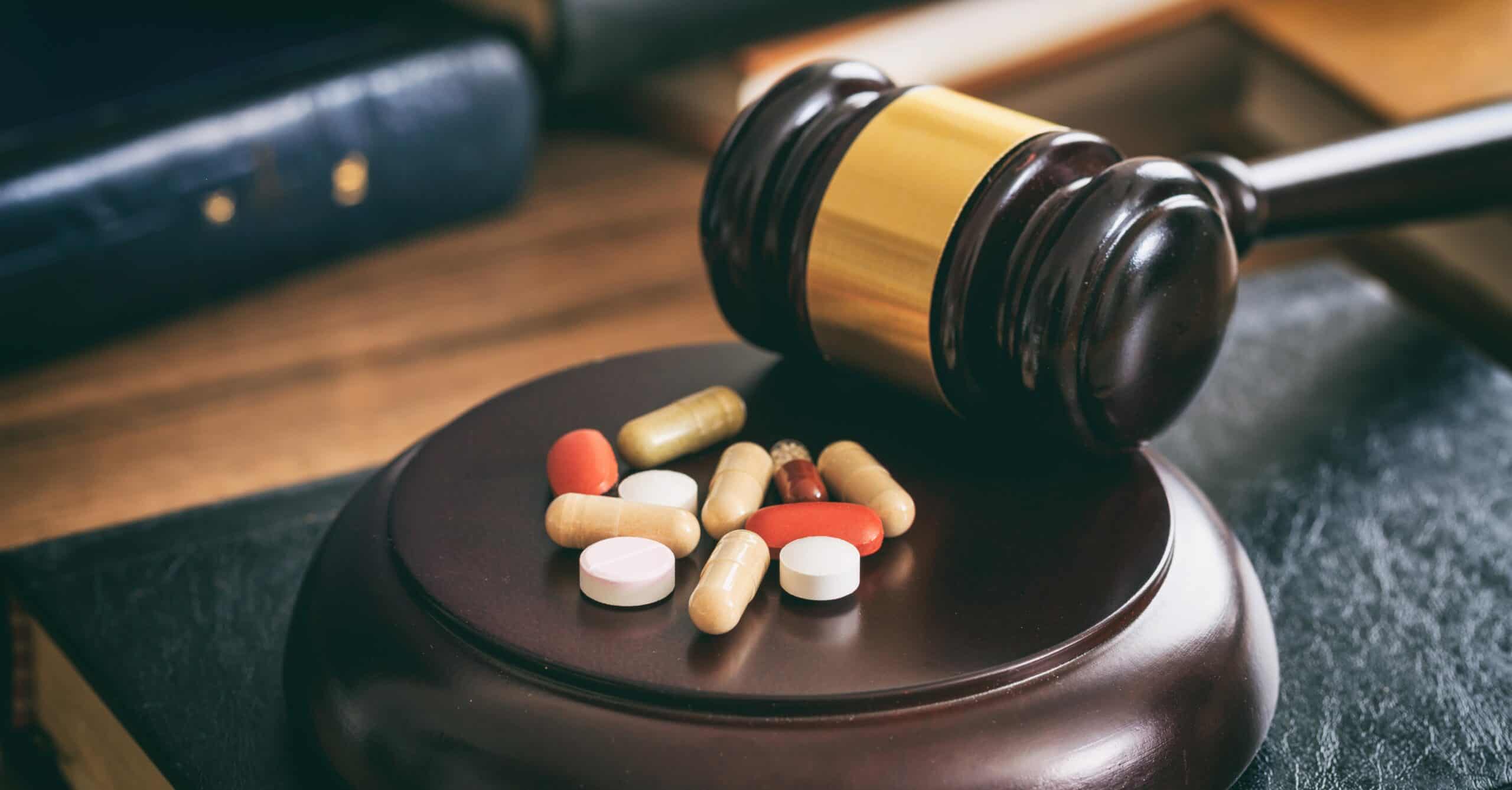 Pills laying beside judges gavel